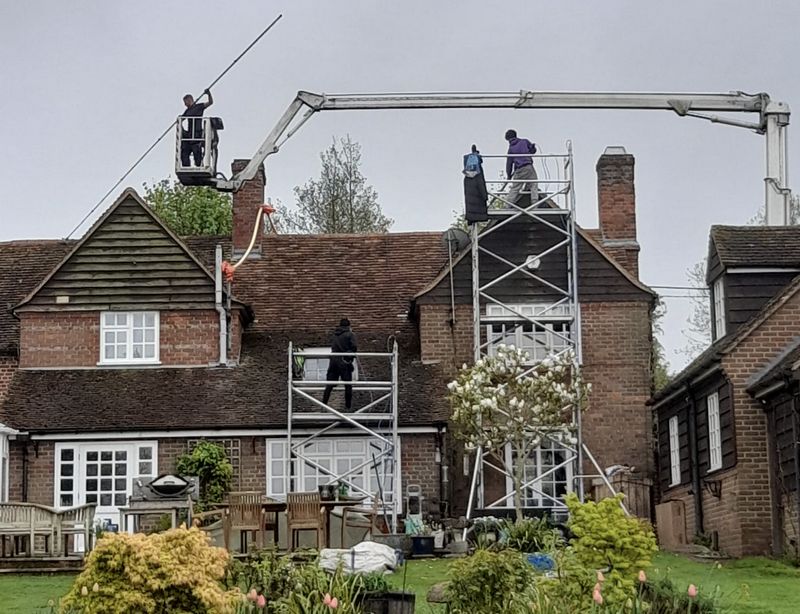 The Roof Moss Cleaners using cherry picker and scaffolding to clean roof safely and professionally in Calne, Wiltshire